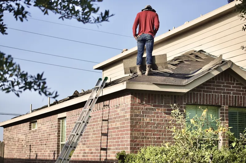 Professional roofer working on a residential roof in Valley Mill Farms